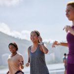 Three women jogging outdoors in an active, health-focused lifestyle, representing the shift toward non-toxic living and holistic wellness choices