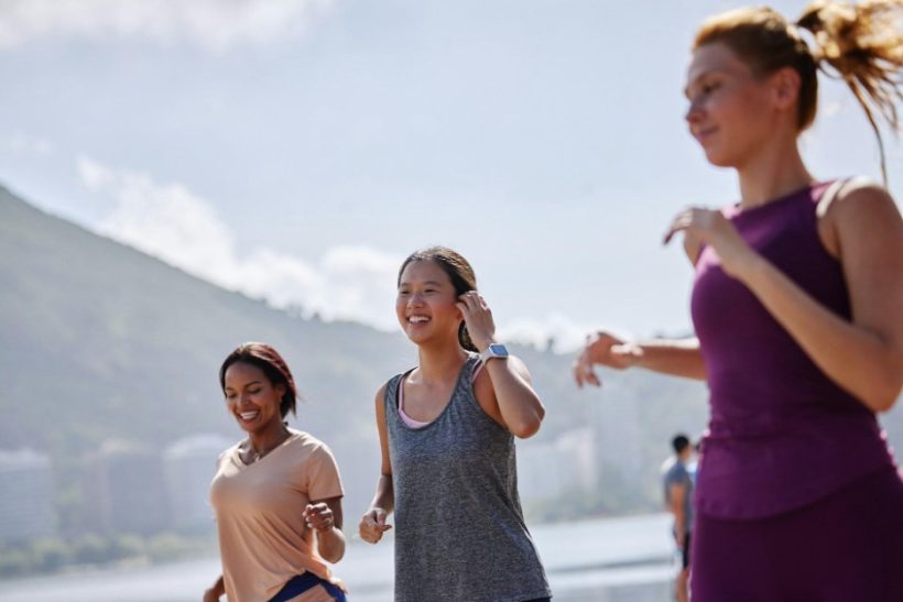 Three women jogging outdoors in an active, health-focused lifestyle, representing the shift toward non-toxic living and holistic wellness choices